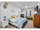 Spacious bedroom with comfortable seating area, TV, and decor at 1224 N Olney St, Indianapolis, IN 46201