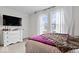 Cozy bedroom with light neutral carpet, white walls, and TV at 1224 N Olney St, Indianapolis, IN 46201