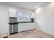 Clean kitchen with stainless steel appliances, black countertop, and ample white cabinet storage at 1224 N Olney St, Indianapolis, IN 46201