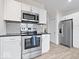 Bright kitchen with stainless steel appliances, white cabinetry, and modern countertops at 1224 N Olney St, Indianapolis, IN 46201