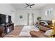 Cozy living room featuring hardwood floors, a ceiling fan, and ample natural light at 1224 N Olney St, Indianapolis, IN 46201