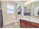 Well-lit bathroom with a window, single sink vanity, and a shower featuring a patterned curtain and soft, warm color palette at 1225 Middlebury Dr, Westfield, IN 46074