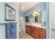 Bright bathroom featuring a double sink vanity with modern fixtures, a glass door shower, and soft blue walls at 1225 Middlebury Dr, Westfield, IN 46074