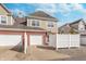 Charming two-story home with a brick facade, attached garages, landscaped yard, and shingle accents on the upper level at 1225 Middlebury Dr, Westfield, IN 46074