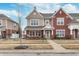 Charming townhouse featuring a covered porch with seating and a combination of brick and siding at 1225 Middlebury Dr, Westfield, IN 46074