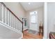 Bright foyer features wood floors, staircase, and a charming bench with coat rack by the front door at 1225 Middlebury Dr, Westfield, IN 46074