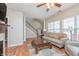 Spacious living room features a fireplace, built-in shelving, hardwood flooring and natural light at 1225 Middlebury Dr, Westfield, IN 46074