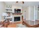 Bright and airy living room with a fireplace, hardwood floors, and built-in shelving at 1225 Middlebury Dr, Westfield, IN 46074