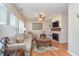 Cozy living room with a fireplace, hardwood floors, and plenty of natural light at 1225 Middlebury Dr, Westfield, IN 46074