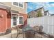 Charming outdoor patio features a table with chairs, framed by a brick wall and white fence, offering an inviting space at 1225 Middlebury Dr, Westfield, IN 46074