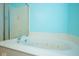 Bathroom with a large soaking tub, tiled floor, and shower with glass doors at 1288 Ivory Ct, Greenwood, IN 46143
