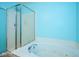 Bathroom featuring a soaking tub with blue walls and glass shower door at 1288 Ivory Ct, Greenwood, IN 46143