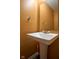 Small bathroom with a pedestal sink, stylish mirror, and towel bar against a warm orange wall at 1288 Ivory Ct, Greenwood, IN 46143