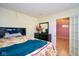 Cozy bedroom featuring a bed, dresser, and doorway leading to another room with a chandelier at 1288 Ivory Ct, Greenwood, IN 46143