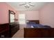 A bedroom with pink walls has a window and a dresser topped with flowers at 1288 Ivory Ct, Greenwood, IN 46143