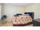 A cute bedroom has a dark bedframe with storage and a floral bedspread set against off-white walls at 1288 Ivory Ct, Greenwood, IN 46143
