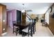 Bright dining area with dark wood table, modern lighting, and an open floor plan connecting to the living room at 1288 Ivory Ct, Greenwood, IN 46143