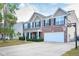 Spacious two-story home with brick and vinyl siding, well-manicured lawn, and an attached two-car garage with basketball hoop at 1288 Ivory Ct, Greenwood, IN 46143