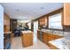 Open-concept kitchen with granite countertops, stainless appliances, maple cabinets and easy access to breakfast area at 1288 Ivory Ct, Greenwood, IN 46143