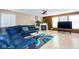 Cozy living room featuring a comfortable blue sectional, fireplace, ceiling fan, and bright windows at 1288 Ivory Ct, Greenwood, IN 46143