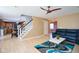 Open concept: Living room with stairs, ceiling fan, and view of the kitchen and dining area at 1288 Ivory Ct, Greenwood, IN 46143