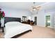 A large primary bedroom is shown with a large bed, wooden furniture, and access to the Primary bath and closet at 1288 Ivory Ct, Greenwood, IN 46143