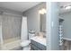 Well-lit bathroom featuring a shower-tub combo and a modern vanity with a sink at 13446 N Carwood Ct, Camby, IN 46113