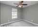Grey carpeted bedroom featuring a ceiling fan, and a window at 13446 N Carwood Ct, Camby, IN 46113