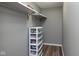 Organized closet with shelves and plastic storage bins on modern vinyl floors at 13446 N Carwood Ct, Camby, IN 46113