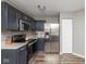 Well-lit kitchen with stainless steel appliances, modern cabinets, and hardwood floors at 13446 N Carwood Ct, Camby, IN 46113