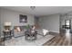 Comfortable living room featuring hardwood floors, neutral paint, a plush couch, and stylish decor at 13446 N Carwood Ct, Camby, IN 46113