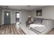 Comfortable living room featuring hardwood floors, neutral paint, a plush couch, and stylish decor at 13446 N Carwood Ct, Camby, IN 46113