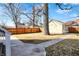 Backyard featuring lawn, sidewalks, fence, and the back of the detached garage at 1422 Carrollton Ave, Indianapolis, IN 46202