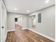 Open basement area with hardwood floors, recessed lighting, and doorway to bar area at 1422 Carrollton Ave, Indianapolis, IN 46202