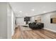 Finished basement featuring a bar, modern lighting, wood floors, and a comfortable sectional couch at 1422 Carrollton Ave, Indianapolis, IN 46202
