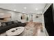 Finished basement with a sectional couch, modern decor, and hardwood flooring at 1422 Carrollton Ave, Indianapolis, IN 46202