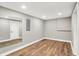 Basement room with hardwood floors, large mirror, and doorway to other parts of the basement at 1422 Carrollton Ave, Indianapolis, IN 46202