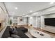 Basement featuring modern decor, hardwood flooring, a sectional couch, and TV at 1422 Carrollton Ave, Indianapolis, IN 46202