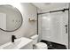 Modern bathroom with black framed glass shower, white subway tile, floating shelves, and contemporary fixtures at 1422 Carrollton Ave, Indianapolis, IN 46202