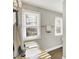 Bathroom featuring a sink with granite countertop, window with blinds, and neutral decor at 1422 Carrollton Ave, Indianapolis, IN 46202