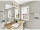 Well-lit bathroom featuring a sink with granite countertop, modern lighting, and neutral decor at 1422 Carrollton Ave, Indianapolis, IN 46202