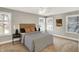 Cozy bedroom featuring a plush bed, side tables, and large windows at 1422 Carrollton Ave, Indianapolis, IN 46202