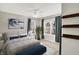 Staged bedroom with carpeted floors, modern decor, large windows, and decorative shelves at 1422 Carrollton Ave, Indianapolis, IN 46202