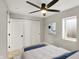 Cozy bedroom featuring neutral carpet, ceiling fan, and closet with sliding doors at 1422 Carrollton Ave, Indianapolis, IN 46202