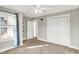 Bright bedroom featuring a ceiling fan, carpeted floor, and large closet with white doors at 1422 Carrollton Ave, Indianapolis, IN 46202