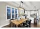 Bright dining area adjacent to kitchen featuring a rustic wood table and contemporary lighting at 1422 Carrollton Ave, Indianapolis, IN 46202