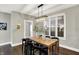 Charming dining room featuring a rustic wood table and modern lighting at 1422 Carrollton Ave, Indianapolis, IN 46202