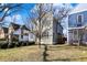 Charming two-story home boasts a manicured lawn, complemented by lush green bushes and mature trees at 1422 Carrollton Ave, Indianapolis, IN 46202