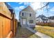 Charming two-story home featuring a front yard with a sidewalk leading to the entrance and a wooden fence at 1422 Carrollton Ave, Indianapolis, IN 46202