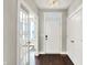 Bright foyer with wood floors, white trim, closet and French doors, offering a welcoming entrance to the home at 1422 Carrollton Ave, Indianapolis, IN 46202